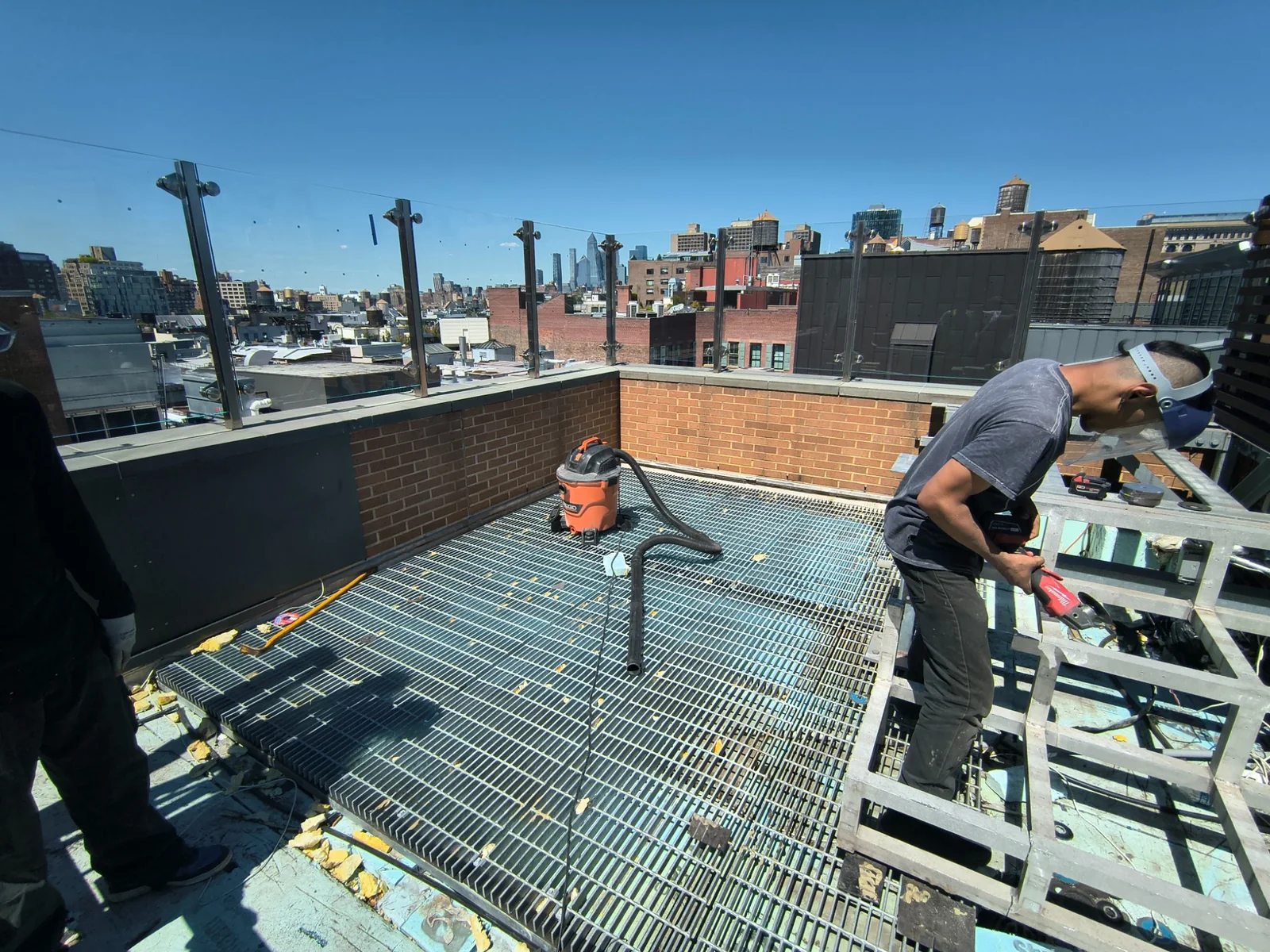 Exposed steel grating after rooftop hot tub demolition in Manhattan