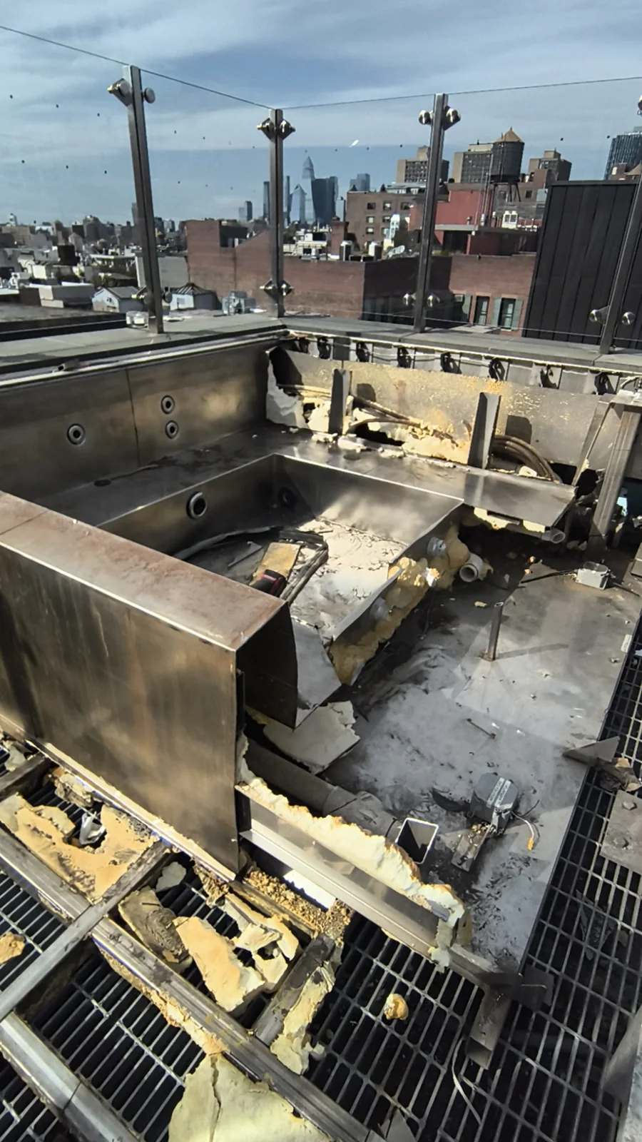 Stainless-steel rooftop hot tub during demolition