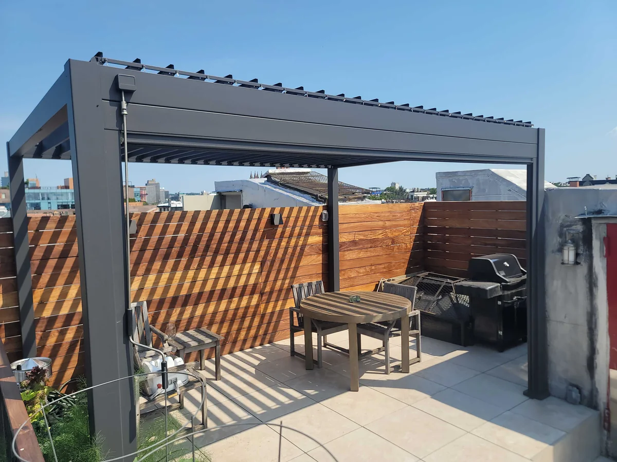 Louvered pergola creating shade above an outdoor dining area