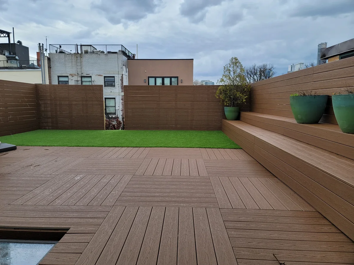 Rooftop synthetic turf with composite decking, built-in seating and privacy screening