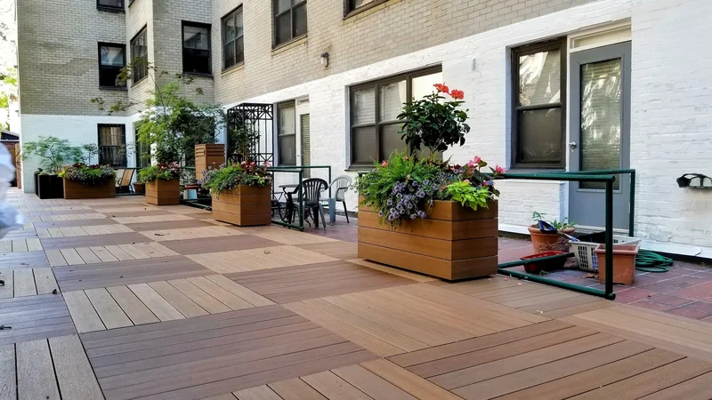 Coordinated planters bring greenery to a long outdoor living space.